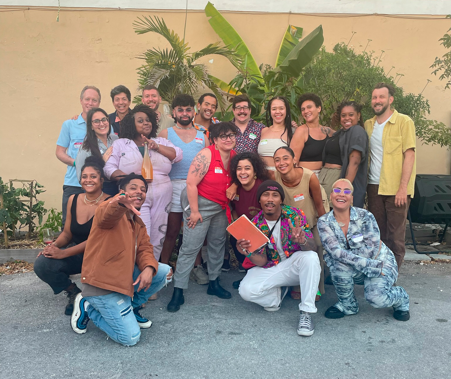 A group of people huddled together to take a picture at an ABV Ferments event.