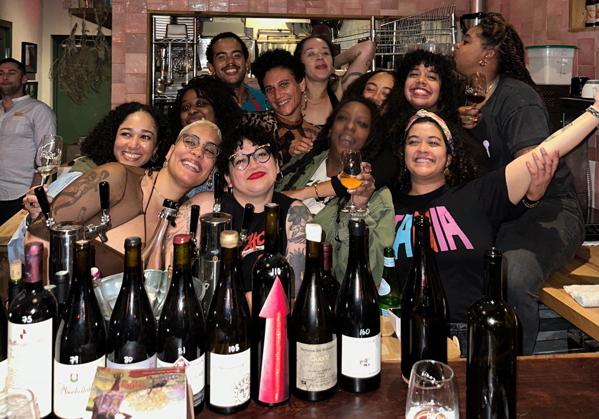 A group of people gathered together at a bar to take a picture at an ABV Ferments event.