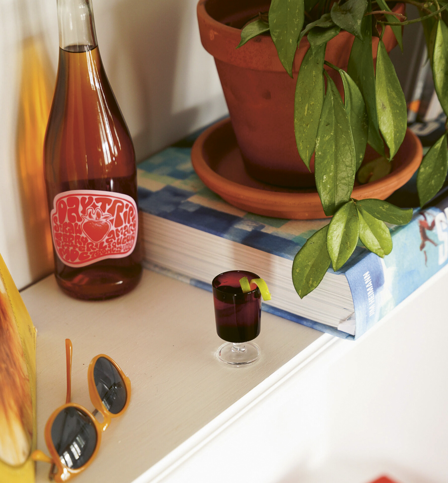 Bottle and poured glass of Simonsig Chenin Blanc, staged on a white table outdoors.