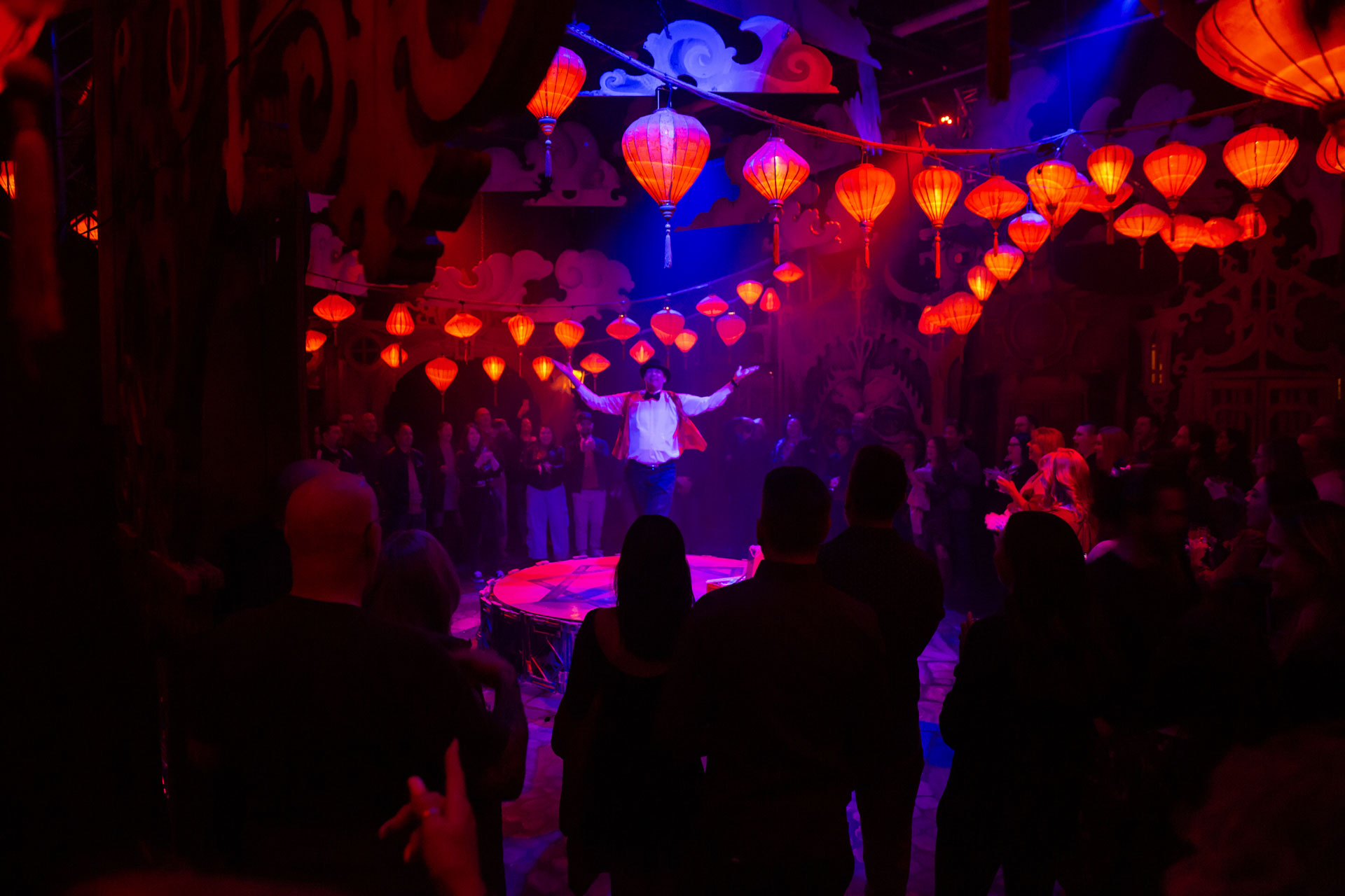A crowd stands around a performer at Lost Spirits Distillery in Los Vegas, NV