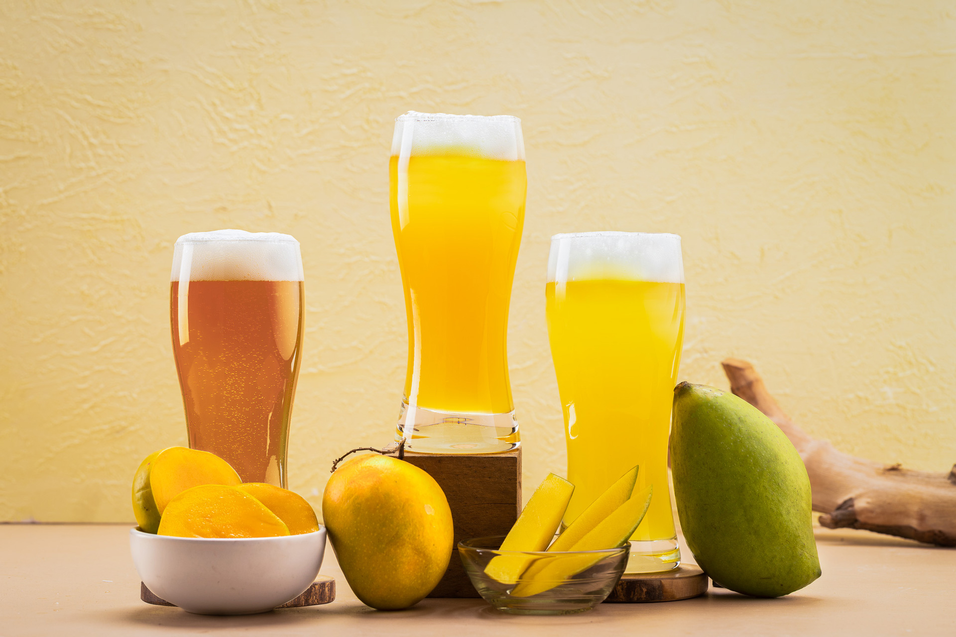 Kimaya Brewing Company beers with local mango—whole and cut—in bowls and on the table around them.