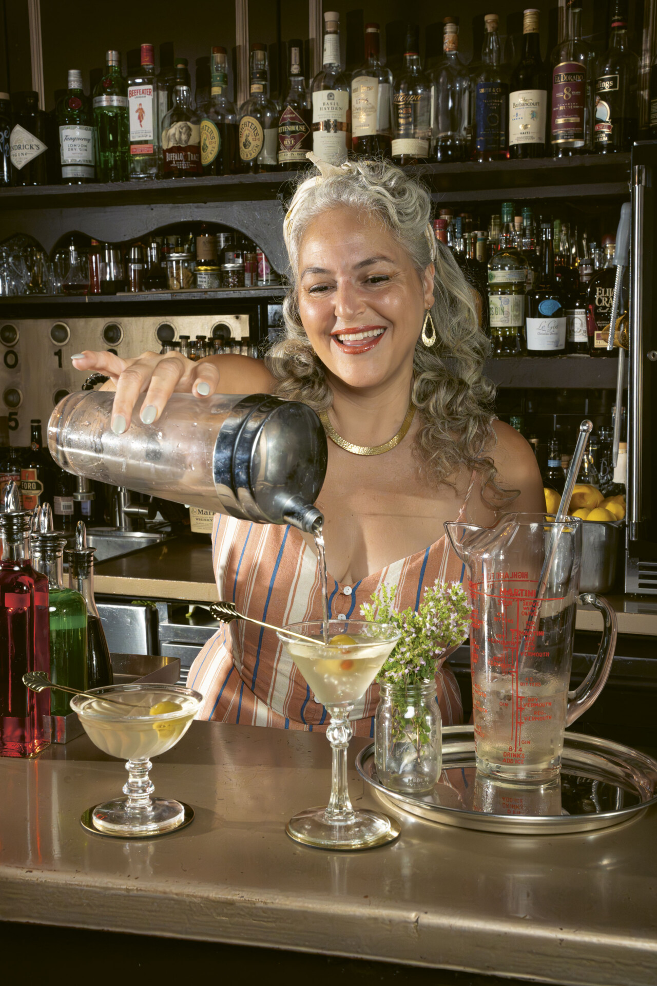 Lynnette Marrero mixing up a drink behind the bar