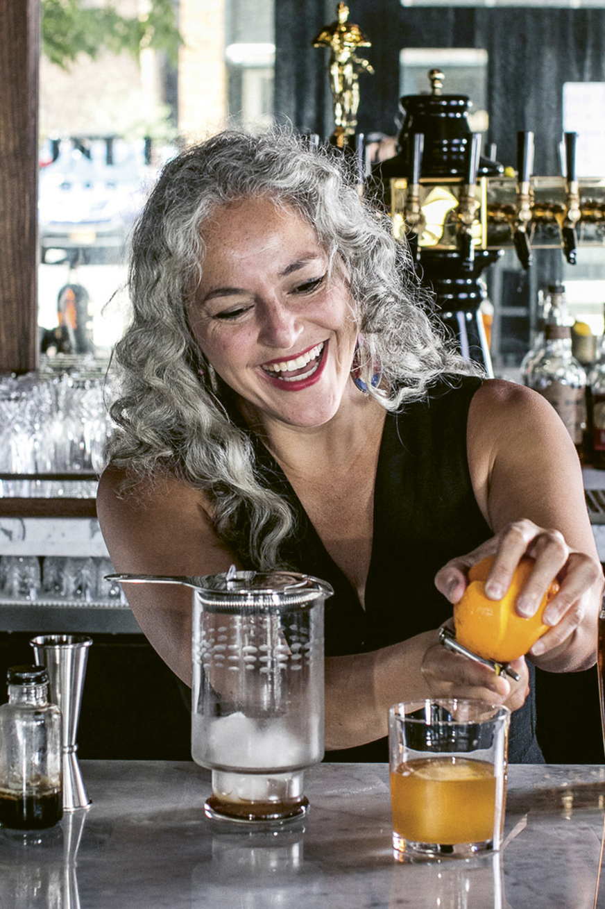 Lynnette Marrero smiles while making a drink