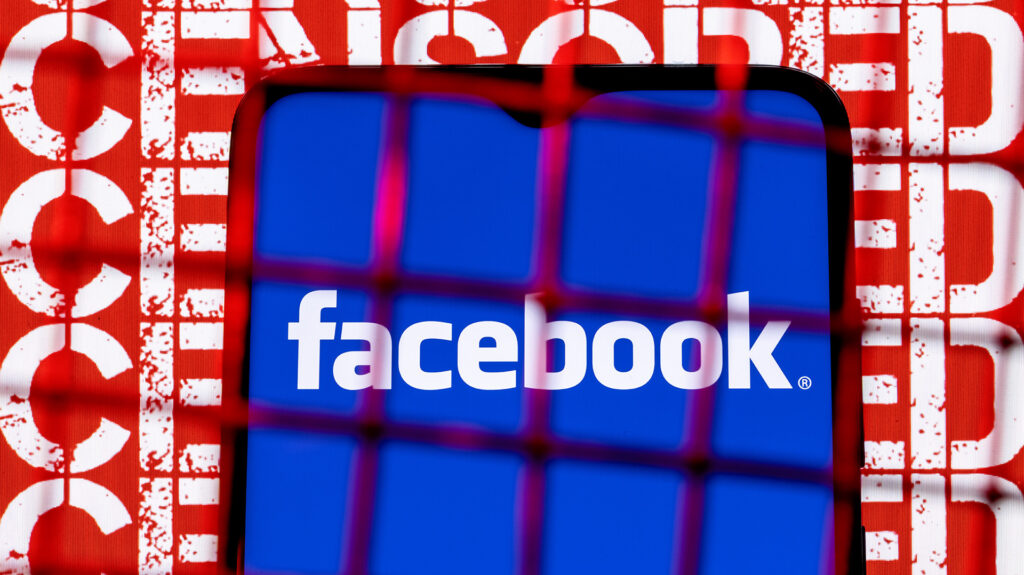 Graphic of a phone with the Facebook type logo on blue background displayed that's covered with red wire grid and the word "Censored" in the background on red.