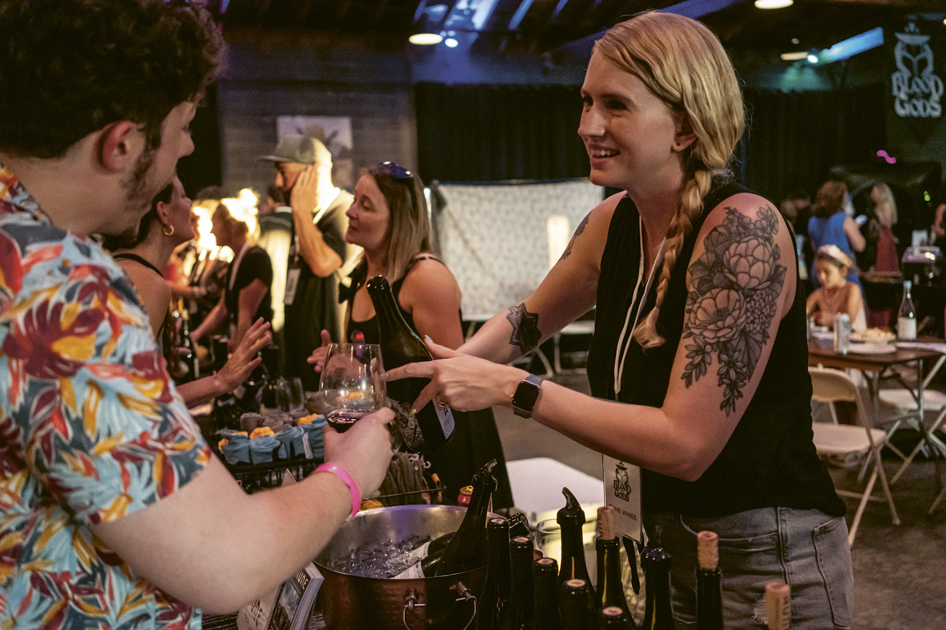 Photograph of someone pouring wine to an attendee of Blood of Gods' Annual Merrymaking Event